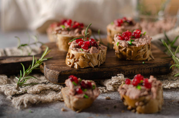 Homemade pate on heathy bread with cranberries Delicious homemade pate with wholegrain pastry and herbs heathy snack stock pictures, royalty-free photos & images