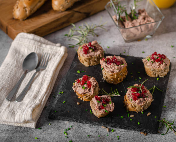 Homemade pate on heathy bread with cranberries Delicious homemade pate with wholegrain pastry and herbs heathy snack stock pictures, royalty-free photos & images