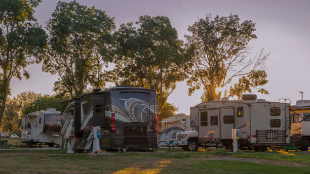 Rv camping at a resort in the early morning A beautiful sunrise at a rv resort with motor homes and tent camping rv stock pictures, royalty-free photos & images
