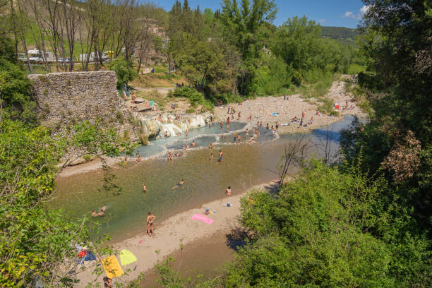 people bathing in pools of thermal spring bagni di petriolo in siena, tuscany, italy - waterfall health spa man made landscape imagens e fotografias de stock