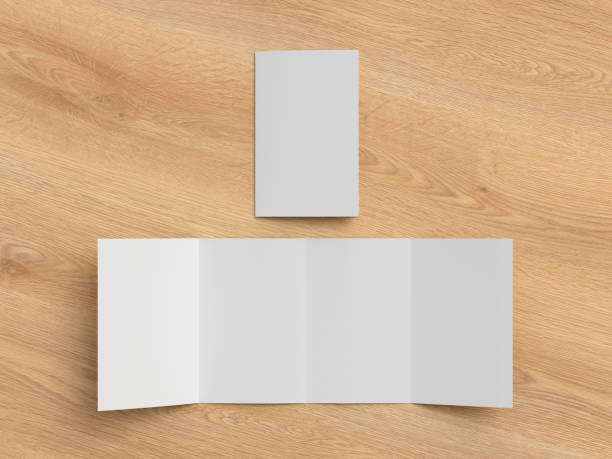 istock Vertical double gate fold brochure. Four panels, eight pages blank leaflet. Mock up on wooden background for presentation design. DDD. 1329236409