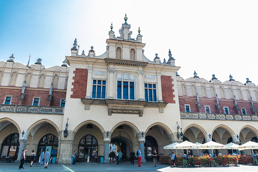 Krakow, Poland - August 28, 2018: Facade of the Rynek Underground Museum in the Main Market Square with people around in Krakow, Poland