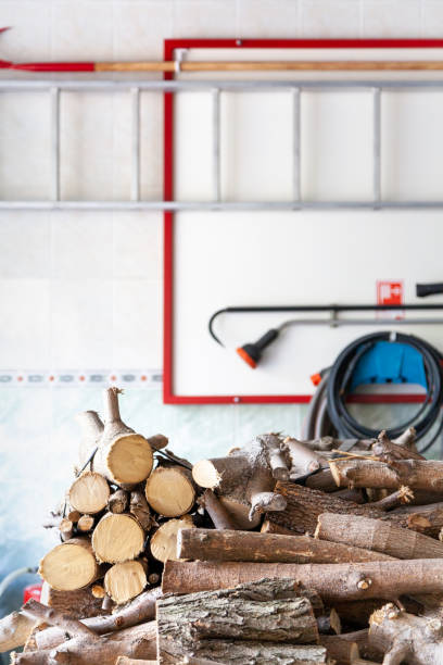 istock Round firewood lie on background of fire shield with inventory 1329241522