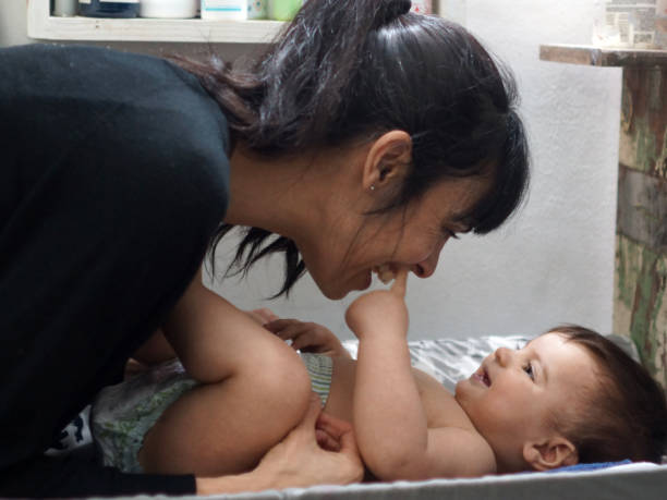 istock mother playing with her baby 1329242705