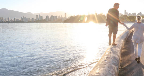 istock Mature couple walk down coastal road at sunrise 1329244970