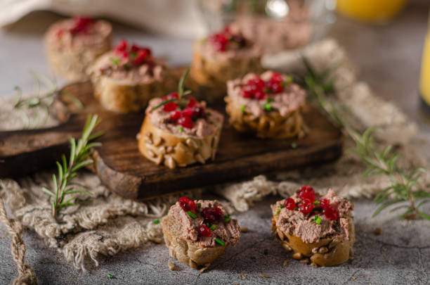 Homemade pate on heathy bread with cranberries Delicious homemade pate with wholegrain pastry and herbs heathy snack stock pictures, royalty-free photos & images