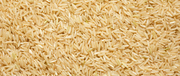 istock Dry Brown Rice background, view from above. Overhead, top view, flat lay. 1329246380
