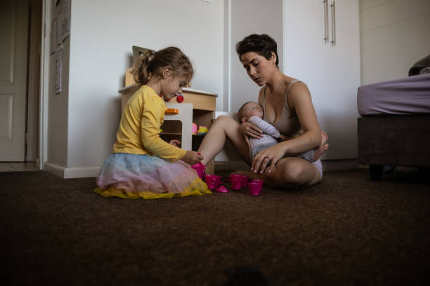 istock Mother with two kids trying to multi-task 1329248572