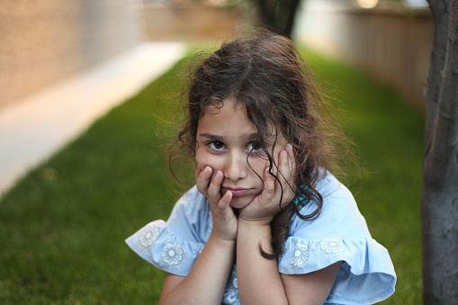 Portrait of a depressed unhappy little girl, cute and sad little girl .