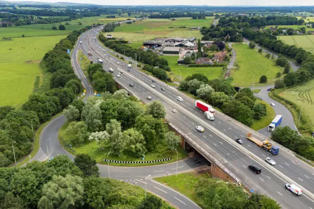 Wide angle aerial view of the M6 Motorway running through Staffordshire, England, UK.
