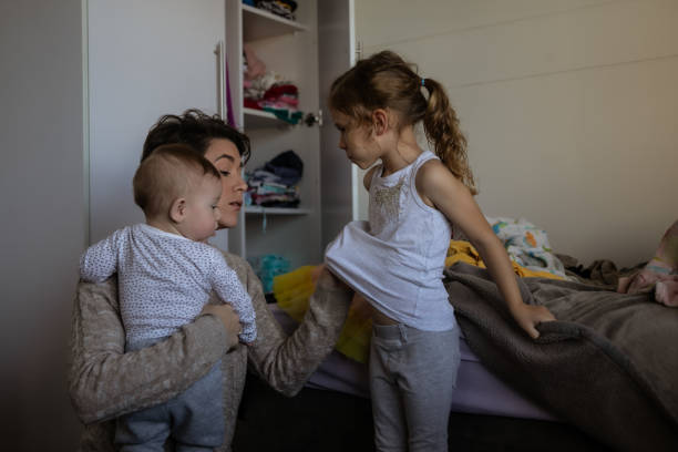 istock Mother with two kids trying to multi-task 1329249034