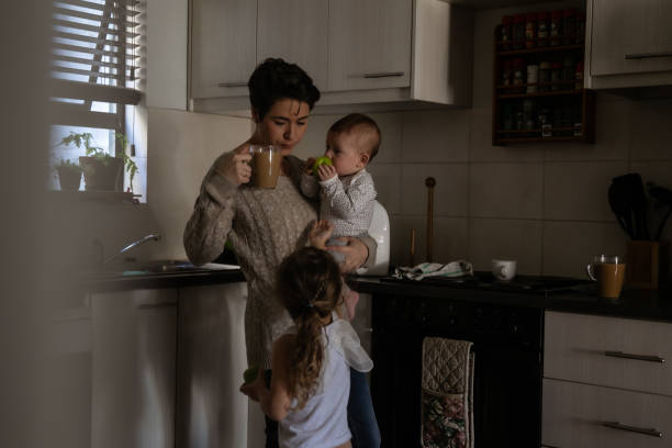 istock Mother with two kids trying to multi-task 1329250094