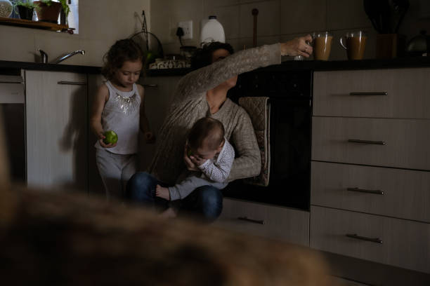 istock Mother with two kids trying to multi-task 1329250165