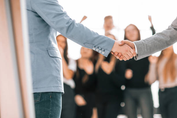istock close up. young business partners shaking hands 1329251307