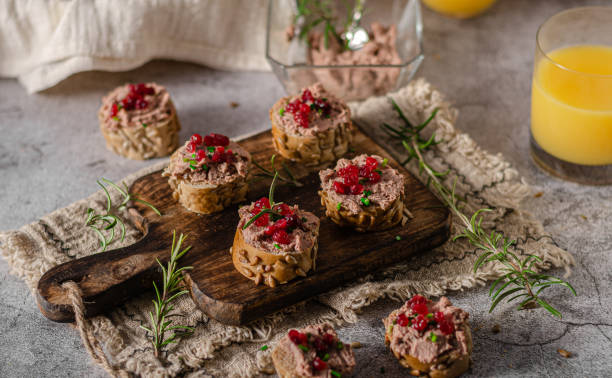 Homemade pate on heathy bread with cranberries Delicious homemade pate with wholegrain pastry and herbs heathy snack stock pictures, royalty-free photos & images