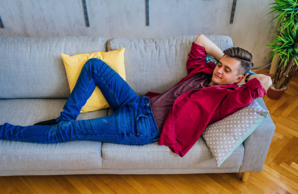 istock Man relaxing on the sofa at home 1329255927