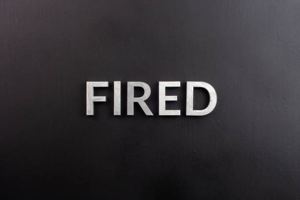 istock the word fired laid with white brushed metal letters on flat black surface 1329256098