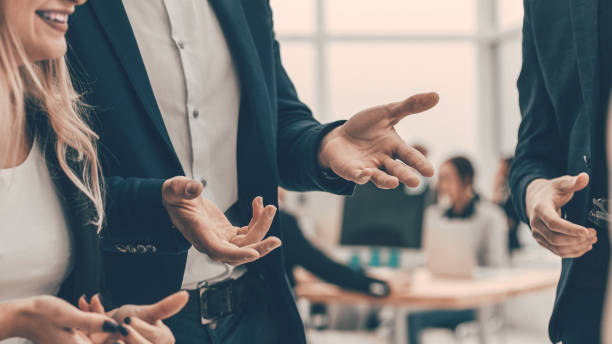 istock business couple talking about something standing in the office 1329256883