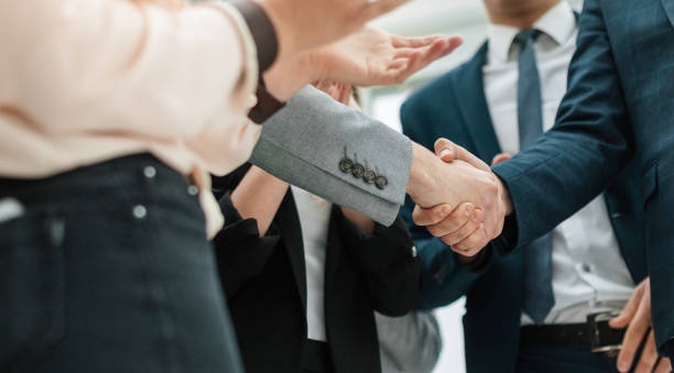 close up. business partners shaking hands in the office stock photo