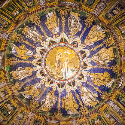 Ravenna, Italy - October 14, 2016: Mosaic cupola in the Neoniano Baptistery in Ravenna - John the Baptist baptizing Jesus and the Apostles round. Masterpiece of byzantine iconography, cerca 5th century