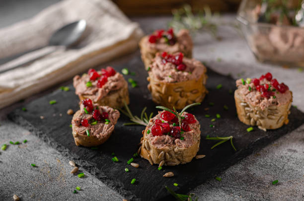Homemade pate on heathy bread with cranberries Delicious homemade pate with wholegrain pastry and herbs heathy snack stock pictures, royalty-free photos & images
