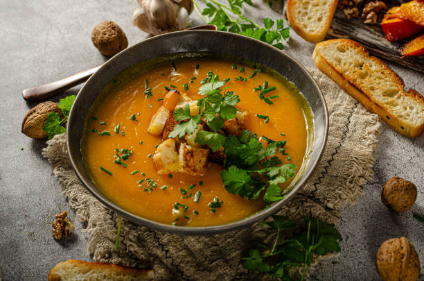 istock Pumpkin soup with herbs and crispy toast 1329260448