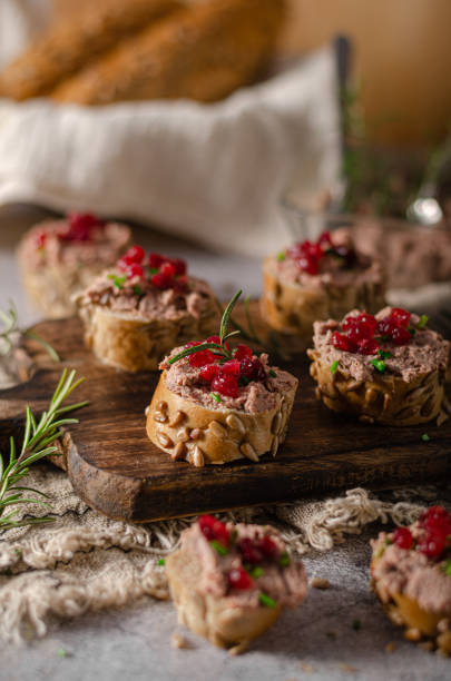 Homemade pate on heathy bread with cranberries Delicious homemade pate with wholegrain pastry and herbs heathy snack stock pictures, royalty-free photos & images