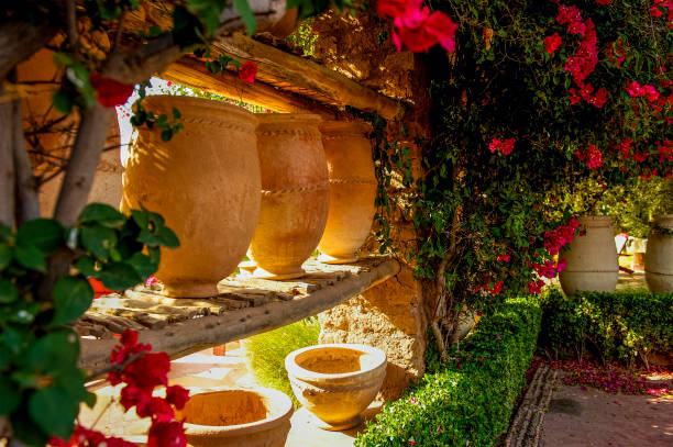 Beautiful terra cotta urns line the walls of this corner of a garden in a lovely outdoor park in Marrakech