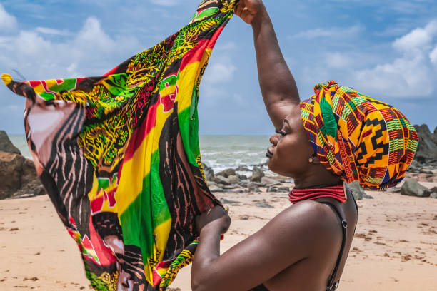 Dancing Ghana woman on the beautiful beach of Axim Dancing Ghana woman on the beautiful beach of Axim, located in Ghana West Africa. Headdress in traditional colors from Africa. ghana photos stock pictures, royalty-free photos & images