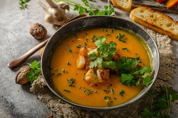 istock Pumpkin soup with herbs and crispy toast 1329266527