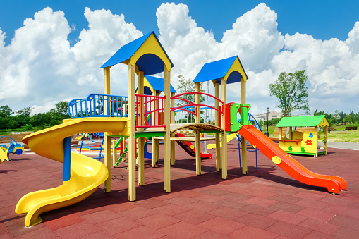 Children playground equipment. Colorful playground empty. Outdoor playground set. Play area. Play yard. Children slide park equipment. School yard. Play ground