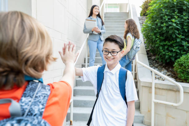 istock Middle school aged student high fiving his friend 1329269029