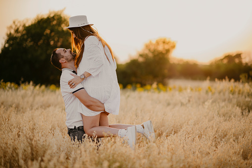 The young couple is enjoying the wheat field