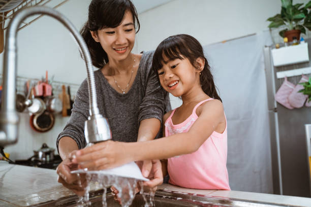 istock kid enjoy washing the dishes together 1329271802