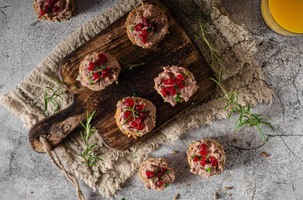 Homemade pate on heathy bread with cranberries Delicious homemade pate with wholegrain pastry and herbs heathy snack stock pictures, royalty-free photos & images