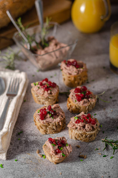 Homemade pate on heathy bread with cranberries Delicious homemade pate with wholegrain pastry and herbs heathy snack stock pictures, royalty-free photos & images