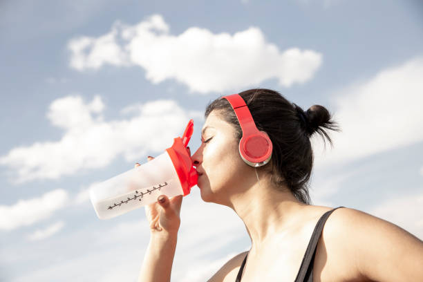 istock sports woman drinking water 1329275478