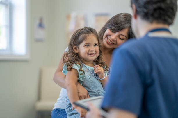 istock Mother and daughter go to doctor's appointment 1329277294