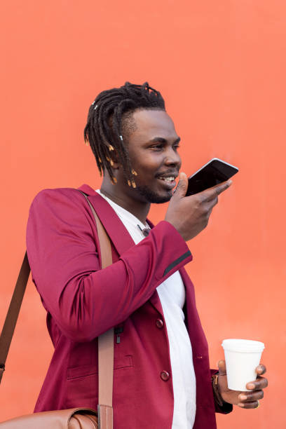 istock stylish african businessman records voice message 1329277562