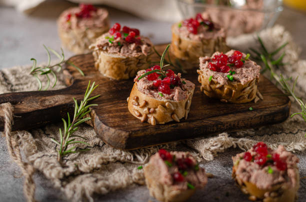 Homemade pate on heathy bread with cranberries Delicious homemade pate with wholegrain pastry and herbs heathy snack stock pictures, royalty-free photos & images