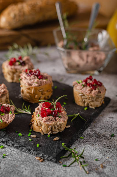 Homemade pate on heathy bread with cranberries Delicious homemade pate with wholegrain pastry and herbs heathy snack stock pictures, royalty-free photos & images