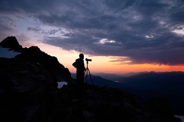 istock Photographer capturing a dramatic sky in the mountains 1329282090