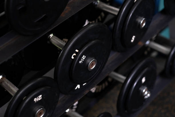 istock black dumbbells in Dark gym interior 1329285800