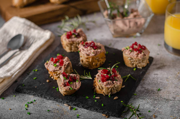 Homemade pate on heathy bread with cranberries Delicious homemade pate with wholegrain pastry and herbs heathy snack stock pictures, royalty-free photos & images