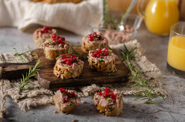 Homemade pate on heathy bread with cranberries Delicious homemade pate with wholegrain pastry and herbs heathy snack stock pictures, royalty-free photos & images