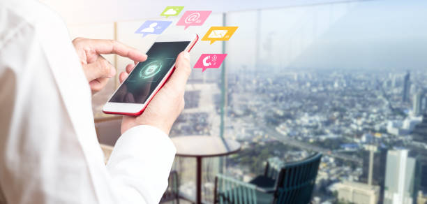 istock Man's hand using smartphone to connecting data information and blurred city background. Panoramic banner of networking technology and social media with copy space 1329288018