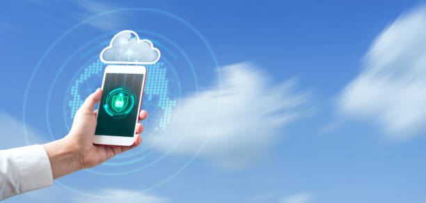 istock Man's hand holding and using smartphone with blurred sky blue background. Cloud Security and Data Protection and Privacy Verification Technology Concept 1329288040