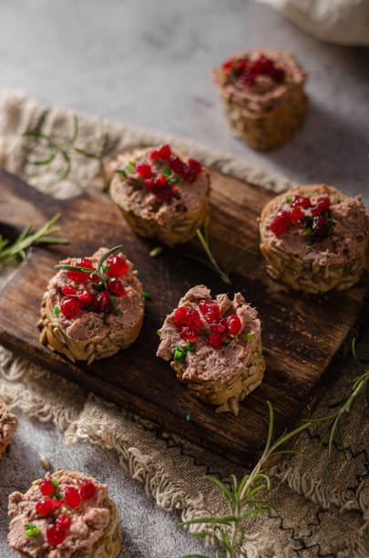 Homemade pate on heathy bread with cranberries Delicious homemade pate with wholegrain pastry and herbs heathy snack stock pictures, royalty-free photos & images