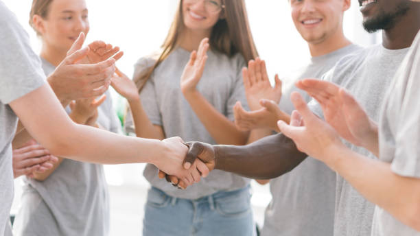 istock close up. youth forum participants applauding their leaders 1329301428