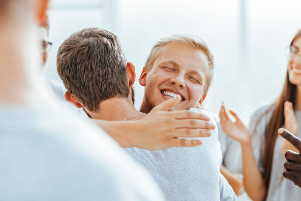 istock close up. happy contestants hugging each other 1329301431